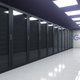 A bank of computer server banks behind glass panes leading down a hall toward the Google logo.
